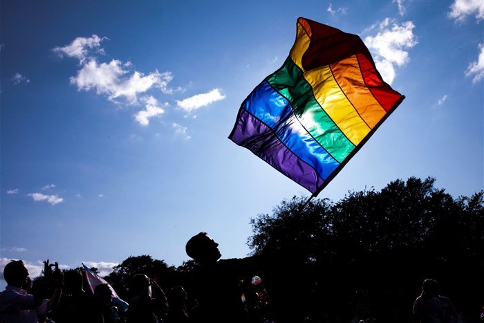 Image: A participant holds a rainbow flag during the WorldPride in Copenhagen, Denmark 21 August 2021. Olafur Steinar Gestsson/Ritzau Scanpix/via Reuters