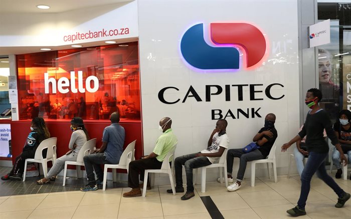 Customers sit on plastic chairs outside Capitec Bank at a mall as South Africa starts to relax some aspects of a stringent nationwide coronavirus disease (Covid-19) lockdown in Soweto on 5 May, 2020. | Source: Reuters/Siphiwe Sibeko