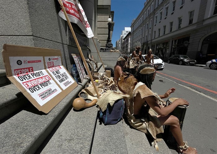 Members of the Khoi, an indigenous group, picket outside the high court during a hearing, opposing housing development for the new Africa headquarters of U.S. retail giant Amazon, in Cape Town. Reuters/Shafiek Tassiem