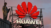The logo of the Chinese telecommunications giant Huawei Technologies is pictured next to a statue on top of a building in Copenhagen, Denmark, 23 June 2021. Reuters/Wolfgang Rattay