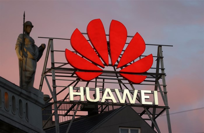 The logo of the Chinese telecommunications giant Huawei Technologies is pictured next to a statue on top of a building in Copenhagen, Denmark, 23 June 2021. Reuters/Wolfgang Rattay