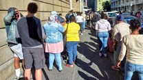 Source: © Groundup Photo: Marecia Damons  People waiting for hours outside Home Affairs in Barrack Street, Cape Town.