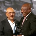 President Ramaphosa presents Anant Singh with his South Africa Investment Conference Business Award.