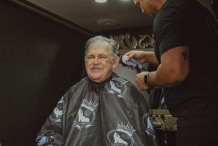 Founder of Dis-Chem, Ivan Saltzman getting his hair cut by Sheldon Tatchell. Source: Supplied