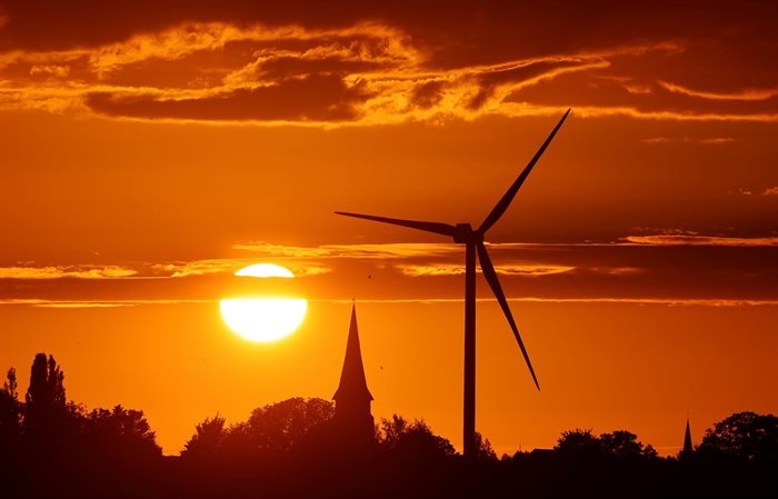 A power-generating windmill turbine and the church of the village are pictured during sunset at a wind park in Ecoust-Saint-Mein, France. Reuters/Pascal Rossignol