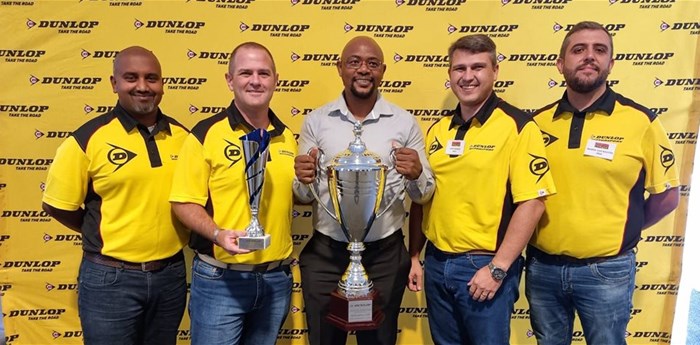 Dunlop Zone Diamond Dealer of the Year<br>David Mogashoa (middle with trophy), owner of Moteti Wheel and Tyre in Mokopane, Limpopo, was named the Dunlop Zone Diamond Dealer of the Year 2021. He also won the Dunlop Zone Regional Diamond Dealer of the Year for Limpopo/Mpumalanga/Swaziland. He is flanked from left to right by Sumitomo Rubber SA’s Darren Chetty (Group director: Sales, Marketing, Operations & Technical), Lubin Ozoux (CEO), Louis Marais (divisional head: Sales Commercial) and Martin Van Rooyen (divisional head: Sales)