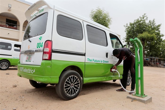 A man plugs a charging cable into a solar-powered minibus at the charging station along Baga-Kazuwa road in Maiduguri, Nigeria on 4 May 2022. Reuters/Afolabi Sotunde