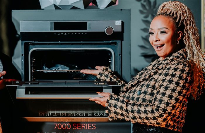 Boity Thulo alongside the new AEG Airfryer Oven, a popular item in the brand's 2022 catalogue.
