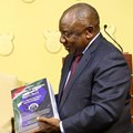 Source: Reuters. South Africa's President Cyril Ramaphosa receives the final investigation report from Chief Justice Raymond Zondo at the government's Union Buildings in Pretoria, South Africa, June 22, 2022.