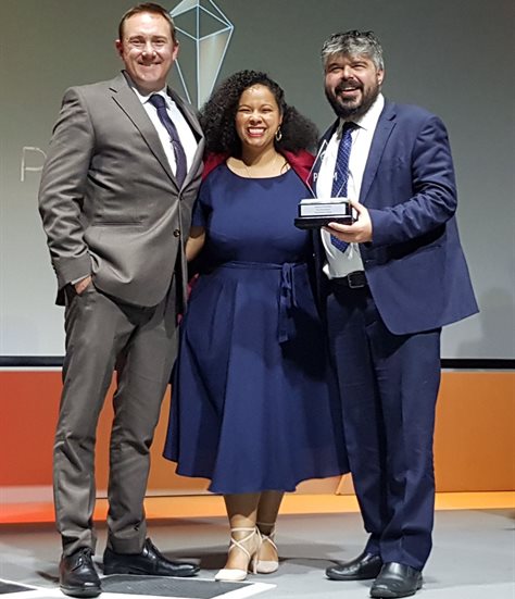 From left to right: Flow’s Roy Barford, Nadia Moore and Richard Frank receive a silver award at the 2022 Prisms