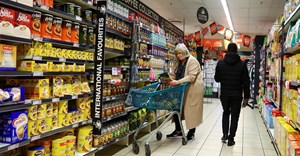 Source: Reuters. A woman uses a trolley as she shops at a grocery store in East London, in the Eastern Cape province.