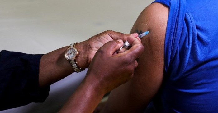 Source: Supplied. Reuters. A healthcare worker administers the Pfizer coronavirus disease (Covid-19) vaccine to a man, amidst the spread of the SARS-CoV-2 variant Omicron, in Johannesburg, South Africa.
