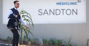 Source: Supplied. A woman walks past the entrance of Mediclinic in Sandton, South Africa.
