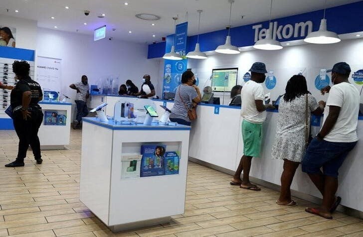 Customers are served at a branch of South Africa's mobile operator, Telkom, in Johannesburg, South Africa, on 2 March 2022. Reuters/Siphiwe Sibeko/File Photo