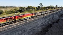 A Transnet Freight Rail train is seen next to tons of coal mined from the nearby Khanye Colliery mine, at the Bronkhorstspruit station, in Bronkhorstspruit, around 90 kilometres north-east of Johannesburg, South Africa, April 26, 2022. REUTERS/Siphiwe Sibeko/File Photo
