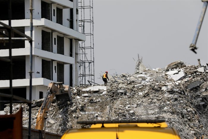 A rescue member works on the debris at the site of a collapsed building in Ikoyi, Lagos. 2021. Reuters/Temilade Adelaja