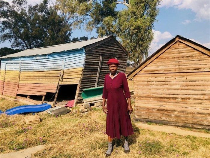 Margaret Makgomola used to run the community Maphuthaditshaba crèche, which can be seen behind her, before the demolitions.