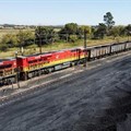 A Transnet Freight Rail train is seen next to tons of coal mined from the nearby Khanye Colliery mine, at the Bronkhorstspruit station, in Bronkhorstspruit, around 90km north-east of Johannesburg, South Africa, 26 April 2022. Reuters/Siphiwe Sibeko