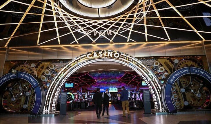 People are seen at the entrance of the Sun International's Times Square Casino ahead of its opening, as South Africa eases some aspects of a stringent nationwide coronavirus disease (COVID-19) lockdown, in South Africa's administrative capital Pretoria, June 29, 2020. REUTERS/Siphiwe Sibeko