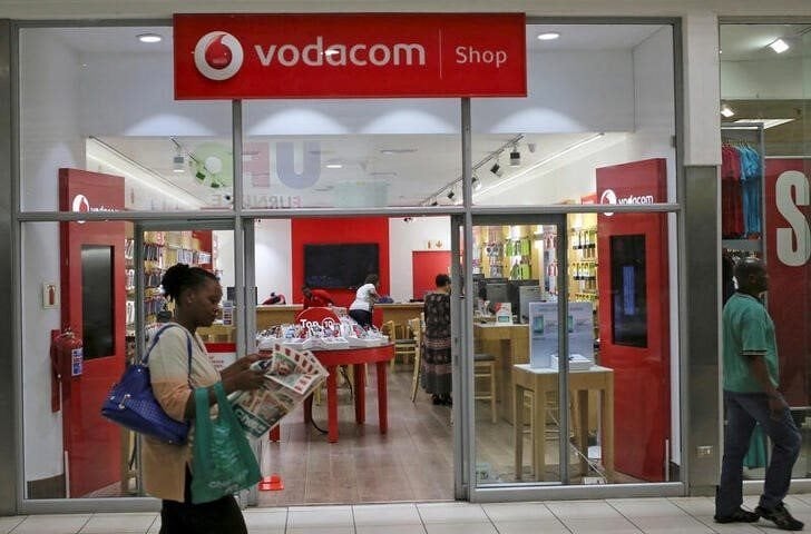 A shopper walks past a Vodacom shop in Johannesburg. Reuters/Siphiwe Sibeko/File Photo