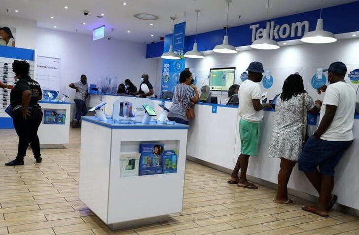Customers are served at a branch of Telkom in Johannesburg on 2 March 2022. Reuters/Siphiwe Sibeko/File Photo
