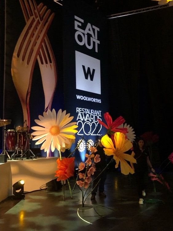 Giant flowers made from paper bringing colour to the stage at the 2022 Eat Out Woolworths Restaurant Awards in Cape Town.