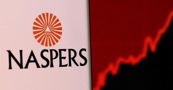 Image: Naspers' logo is pictured on a smartphone in front of stock graph displayed in this illustration taken, 4 December 2021. Reuters/Dado Ruvic/Illustration