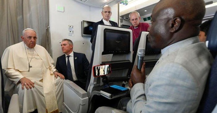 Pope Francis addresses the media while aboard the plane from Juba to Rome, returning from his visit to Democratic Republic of Congo and South Sudan, 5 February 2023. Vatican Media/­Handout via Reuters