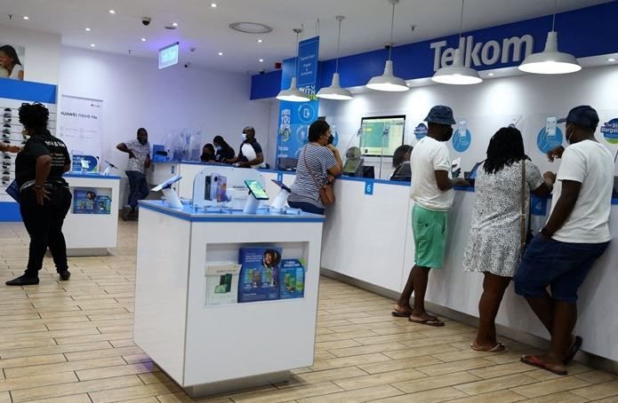 Customers are served at a branch of Telkom, in Johannesburg on 2 March 2022. Reuters/Siphiwe Sibeko/File Photo