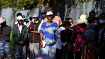 Social grant recipients stand in a queue outside a post office, as joblessness takes its toll in Meadowlands, a suburb of Soweto, South Africa, 24 February 2022. Reuters / Siphiwe Sibeko