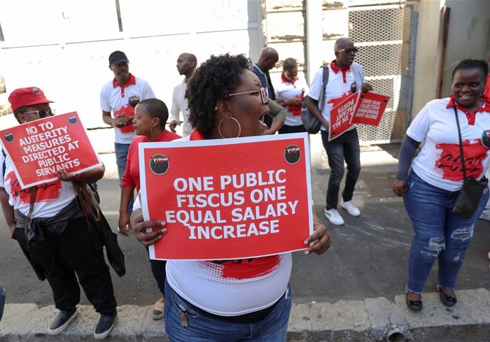 Members of the South African public sector union, National Education, Health and Allied Workers' Union (Nehawu) hold placards outside the Home Affairs office during a protest over wage disputes and other work issues in Cape Town, South Africa, 13 March 2023. Reuters/Esa Alexander