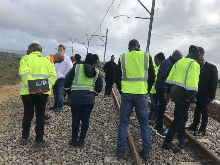 Officials walk along the tracks between station on the central line to assess infrastructure damage.