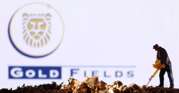 Source: Reuters. A small toy figure and gold imitation are seen in front of the Gold Fields logo in this illustration taken November 19, 2021.