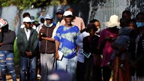 Social grant recipients stand in a queue outside a post office, as joblessness takes its toll in Meadowlands, a suburb of Soweto, South Africa, 24 February 2022. Reuters/Siphiwe Sibeko