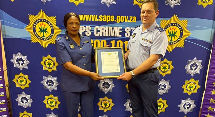 Major General Patricia Rampota and Brigadier Stoltz holding the certificate of appreciation
