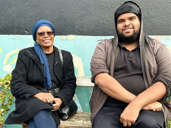 Nadia Agherdine, who co-founded Neighbourhood Gardens, and horticulturist Ismail Johnson sit on a bench in the Chatham Community Garden. The organisation has developed five community gardens in Salt River so far.