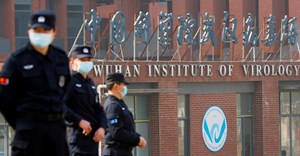 Source: Security personnel keep watch outside the Wuhan Institute of Virology during the visit by the World Health Organization (WHO) team tasked with investigating the origins of the coronavirus disease, in Wuhan, Hubei province, China February 3, 2021.