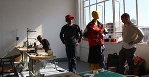 File photo: South African aspiring designers Khumo Morojele and Klein Muis look at one of their designs made from second hand clothing imported from the West and sold in bales in markets known as Dunusa, in Johannesburg South Africa, 3 July 2023.Reuters/Siphiwe Sibeko/File Photo