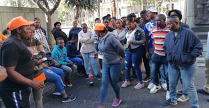 Some of the workers, who were dismissed from the Frimax chip factory in Verulam, Durban, for participating in an unprotected strike last month, wait outside the CCMA. Photo: Tsoanelo Sefoloko / GroundUp