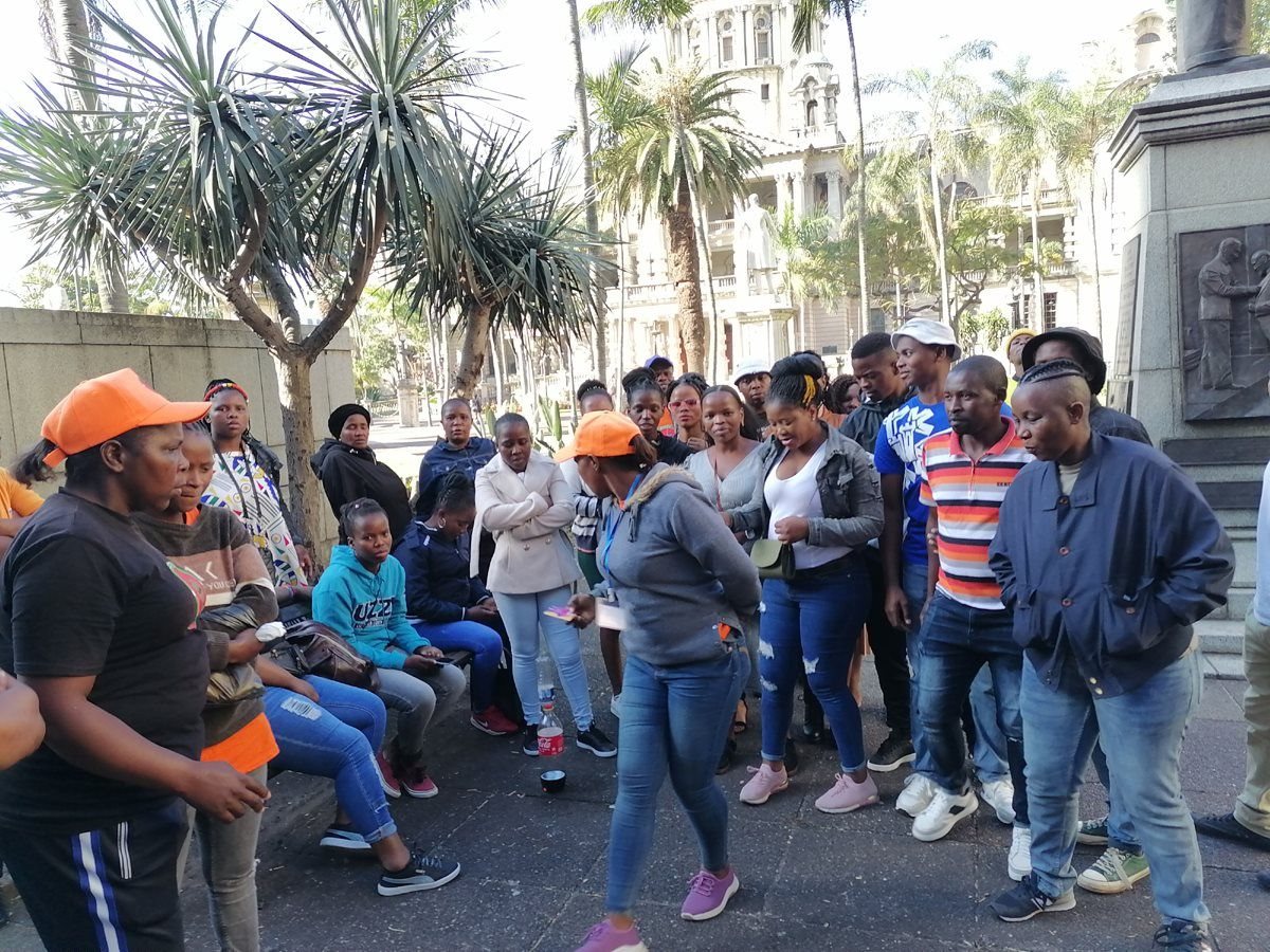 Some of the workers, who were dismissed from the Frimax chip factory in Verulam, Durban, for participating in an unprotected strike last month, wait outside the CCMA. Photo: Tsoanelo Sefoloko / GroundUp