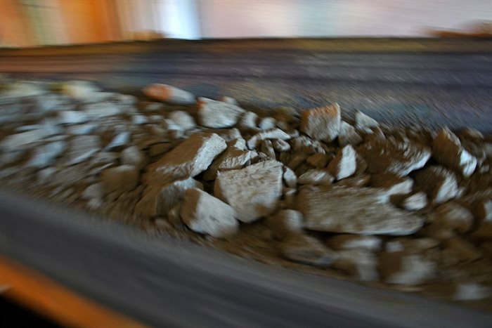 Crushed ore is transported on a conveyor belt. Source: Reuters/Hereward Holland