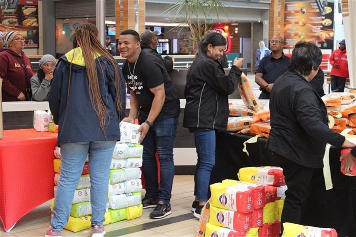 Volunteers, mall staff, retailer staff, and community members joined forces to sort and pack food donations for FoodForwardSA at Liberty Mall