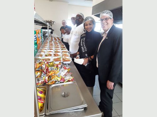 Burger-making production line in the expansive kitchen at the Johannesburg Children's Home, with chefs and staff from City Lodge Hotel at OR Tambo International Airport and Mrs Soweto Finalist 2023 Fatima Moyane.