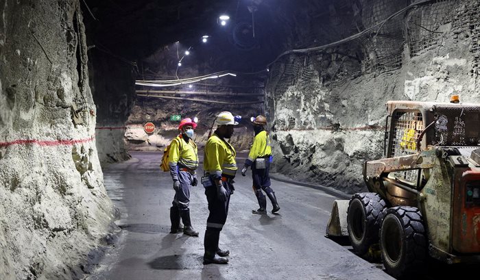 Mine workers stand underground at Gold Fields' South Deep mine, south-west of Johannesburg. 2022. Source: Reuters/Siphiwe Sibeko