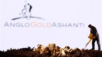 A small toy figure and gold imitation are seen in front of the AngloGold Ashanti logo in this illustration taken November 2021. Source: Reuters/Dado Ruvic