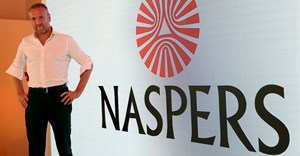 Bob van Dijk, CEO of e-commerce group Naspers, poses for a photograph in front of the company logo after holding a media briefing in Johannesburg. Source: Reuters/Siphiwe Sibeko