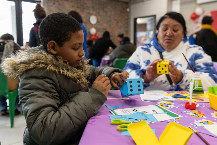 Ten-year-old Kyle Hartley and his grandmother Wilhelmina Hartley from Elsies River create colourful paper dice during the ‘resource making with parents’ workshop.