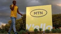 A man walks past an MTN logo outside the company's headquarters in Johannesburg. Source: Reuters/Siphiwe Sibeko