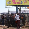 Striking Simba factory workers picket inside the gates of the company’s premises in Isando because security would not let them out to protest. They were eventually let out a couple of hours later. Photos: Kimberly Mutandiro | GroundUp