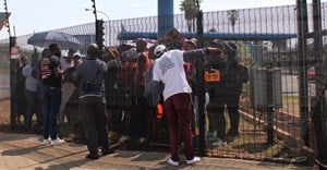 Striking Simba factory workers picket inside the gates of the company’s premises in Isando because security would not let them out to protest. They were eventually let out a couple of hours later. Photos: Kimberly Mutandiro | GroundUp